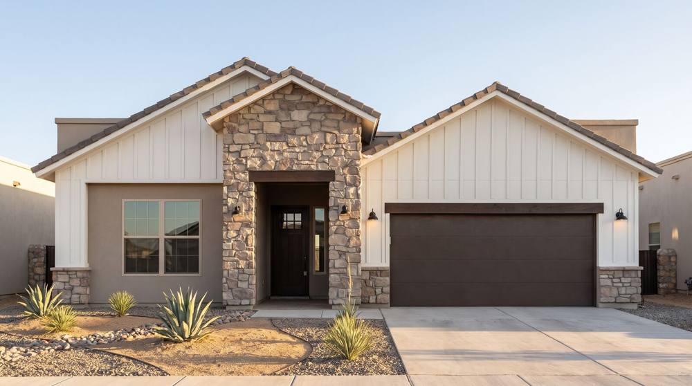 Rendering of the Farmhouse elevation: a stacked-stone entry between white board-and-batten gables, tan stucco and desert landscaping